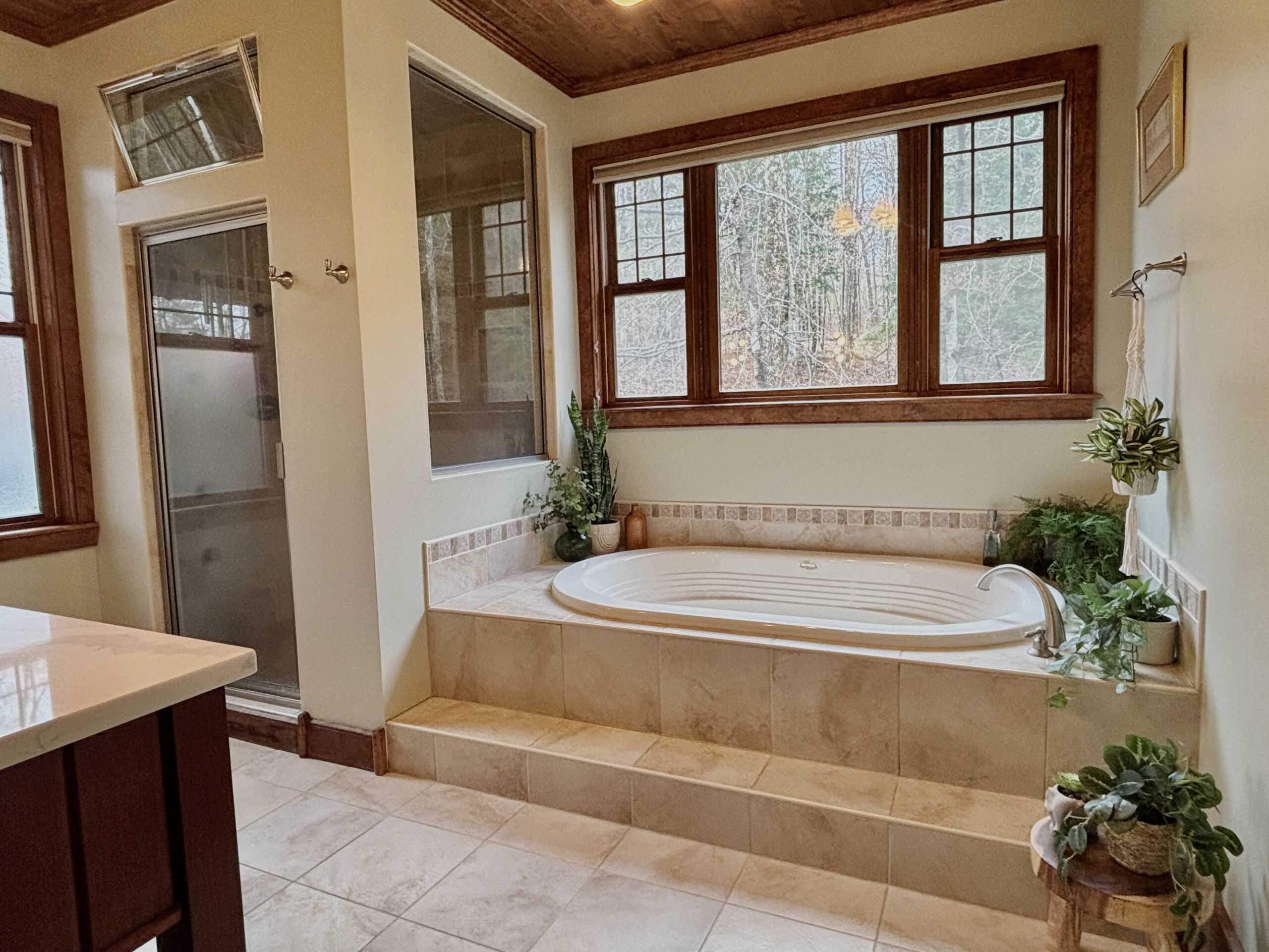 Master en-suite bathroom with large soaking tub and two person rain shower